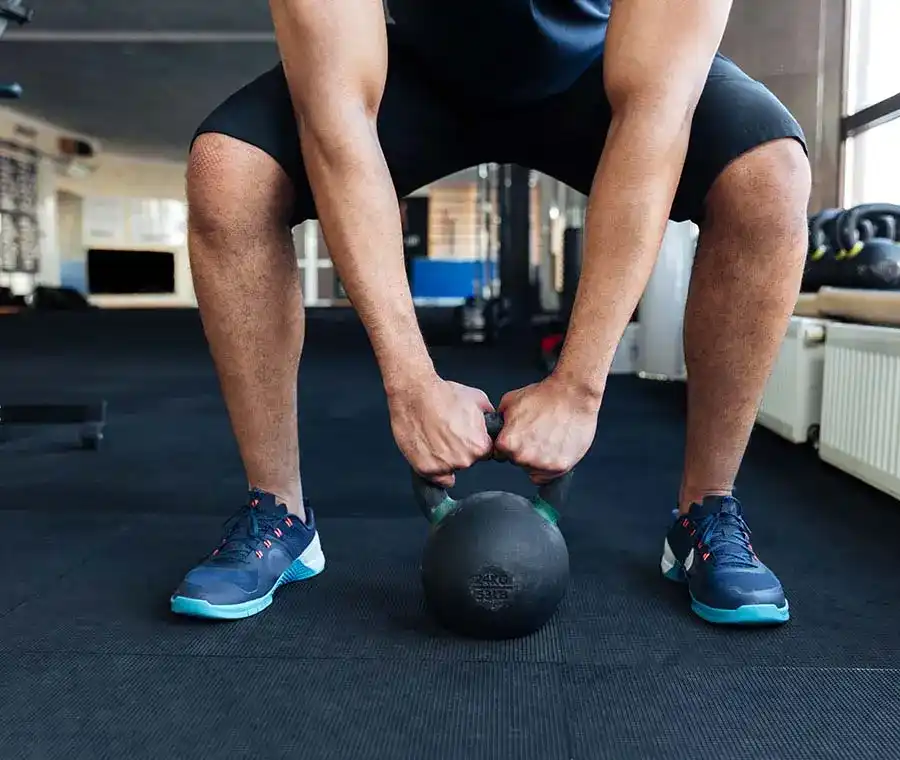 Bodybuilder working out with kettlebell 1